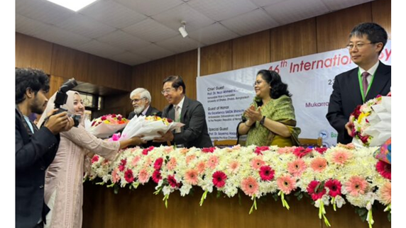Director Otani giving opening remarks and receiving flower