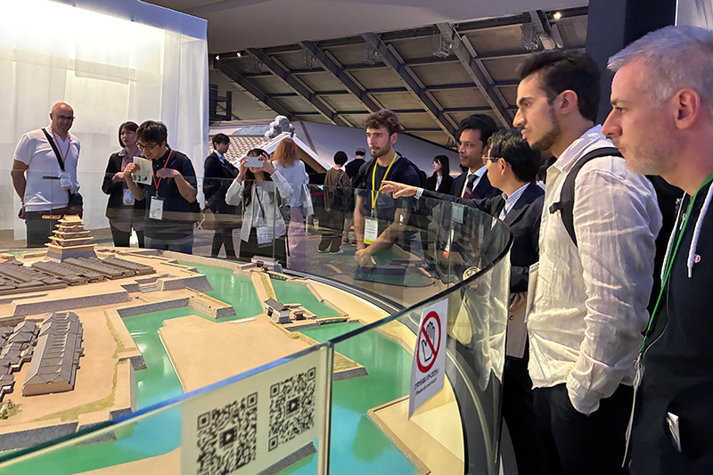 Participants tour an exhibit while listening to an explanation.